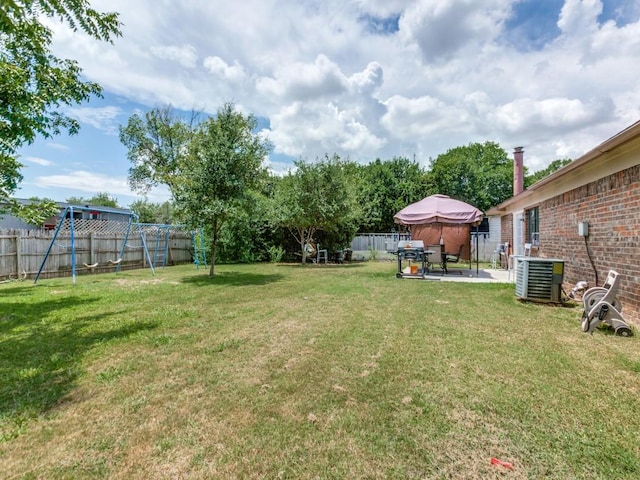 view of yard featuring central AC and a patio