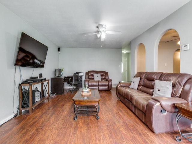 living room featuring ceiling fan and hardwood / wood-style flooring