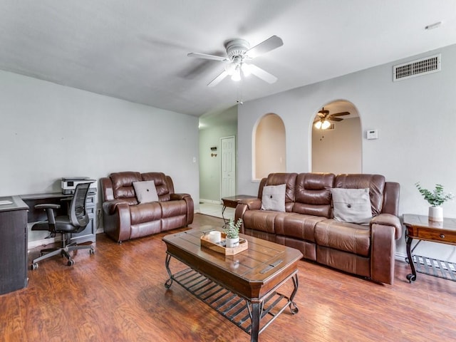 living room featuring ceiling fan and hardwood / wood-style flooring