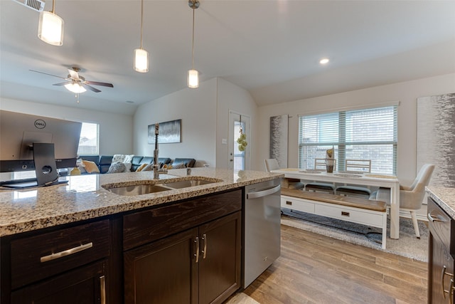 kitchen featuring stainless steel dishwasher, hanging light fixtures, and light stone counters