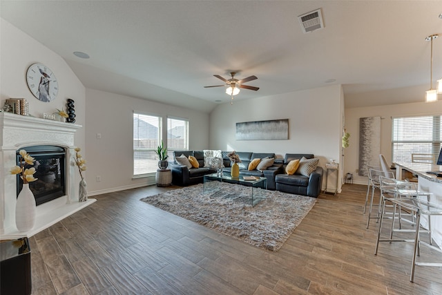 living room featuring ceiling fan and lofted ceiling