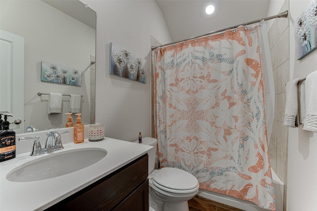 bathroom featuring toilet, tile patterned floors, vanity, and curtained shower