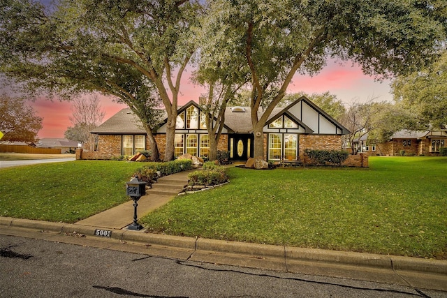 tudor home featuring a lawn