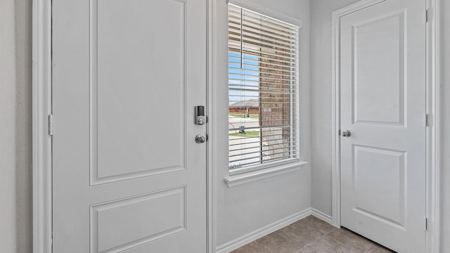 doorway to outside featuring light tile patterned floors