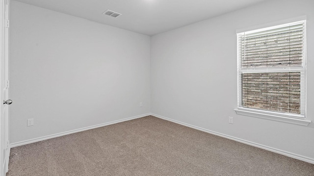 carpeted empty room with a healthy amount of sunlight