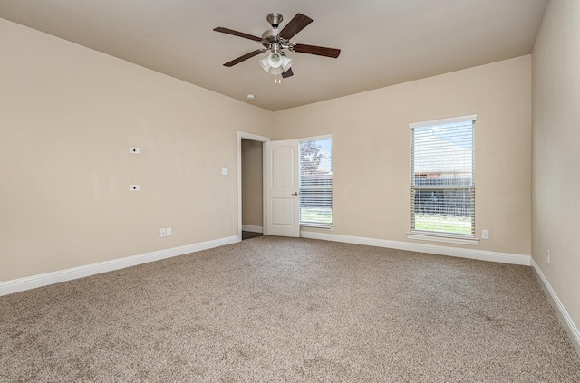 spare room with ceiling fan and carpet