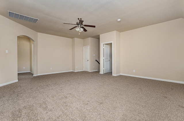 spare room featuring ceiling fan and carpet flooring