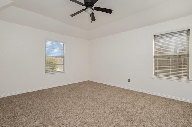 spare room with ceiling fan and carpet