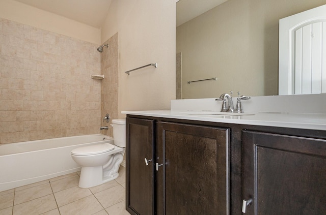 full bathroom featuring tiled shower / bath, vanity, toilet, and tile patterned flooring