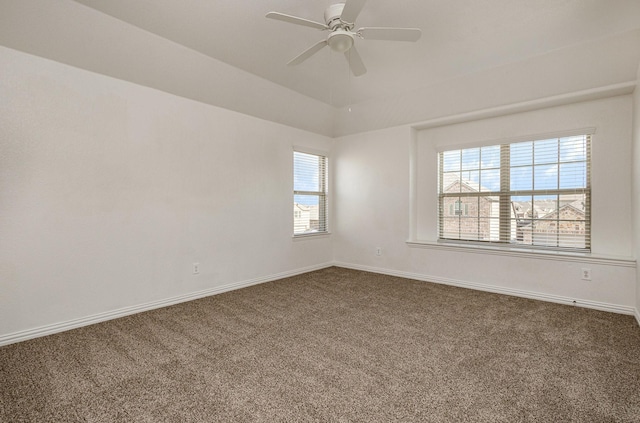 carpeted empty room with ceiling fan and vaulted ceiling