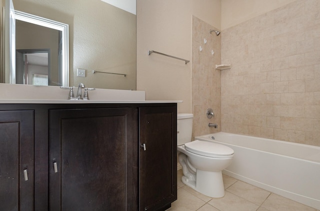 full bathroom with tiled shower / bath combo, vanity, tile patterned floors, and toilet