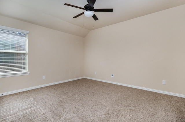 carpeted spare room with ceiling fan and lofted ceiling