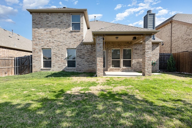 rear view of property with a patio area and a lawn