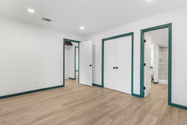 unfurnished bedroom with connected bathroom and light hardwood / wood-style flooring