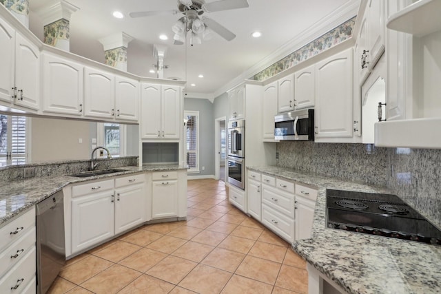 kitchen with backsplash, sink, white cabinets, and appliances with stainless steel finishes