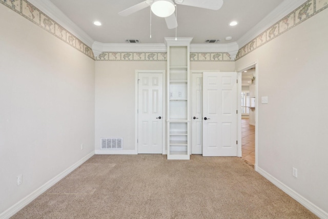 unfurnished bedroom featuring carpet floors, a closet, ornamental molding, and ceiling fan