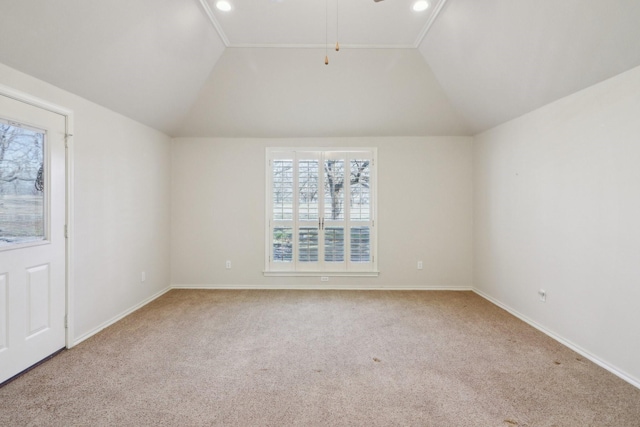 carpeted spare room featuring lofted ceiling