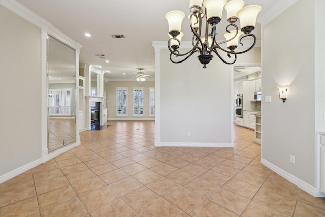 unfurnished dining area with ceiling fan with notable chandelier, ornamental molding, and light tile patterned flooring