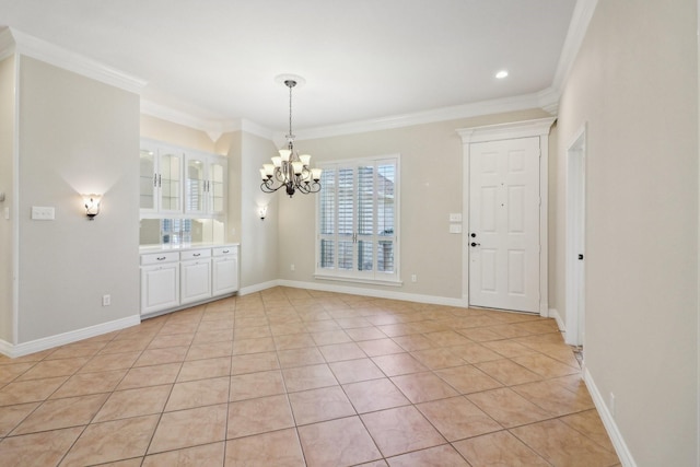 unfurnished dining area with light tile patterned floors, crown molding, and a chandelier