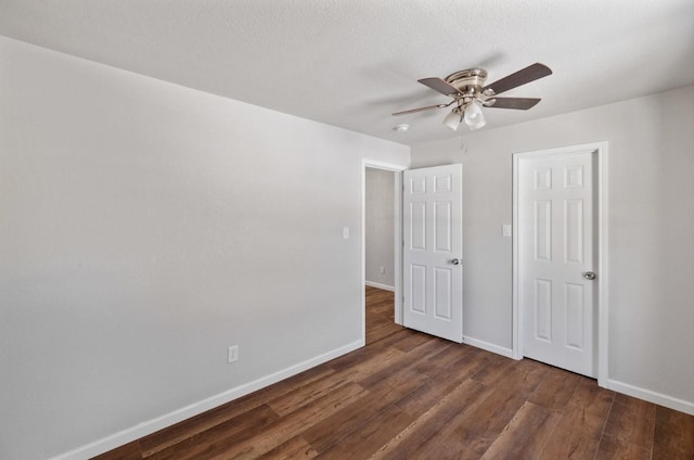 unfurnished bedroom with ceiling fan and dark hardwood / wood-style flooring