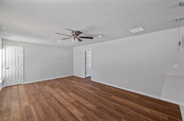 unfurnished room featuring ceiling fan, dark hardwood / wood-style floors, and a textured ceiling