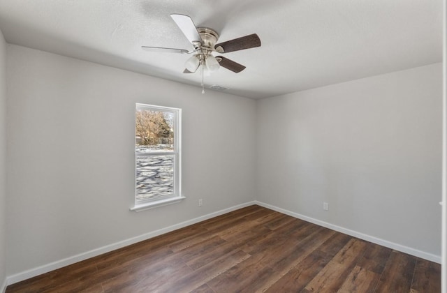 empty room featuring ceiling fan and dark hardwood / wood-style floors