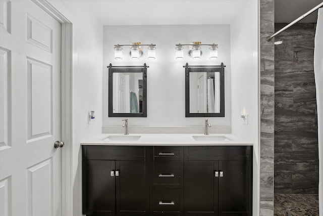 bathroom featuring a shower and vanity