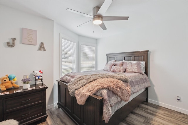 bedroom with ceiling fan and dark hardwood / wood-style floors