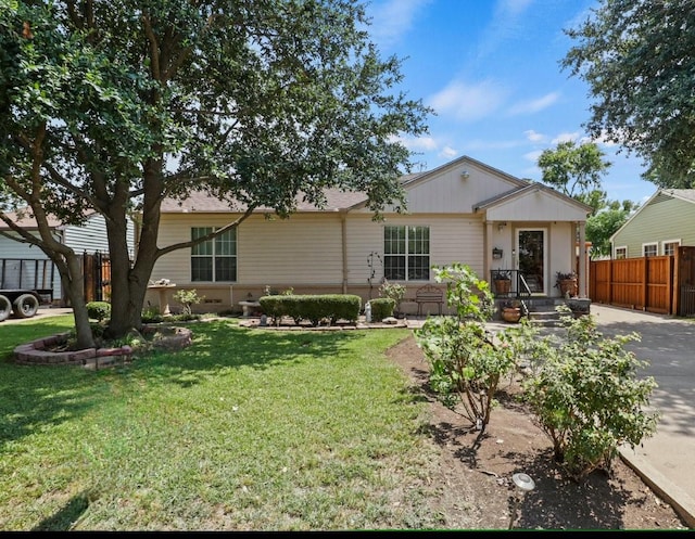 rear view of house featuring a lawn