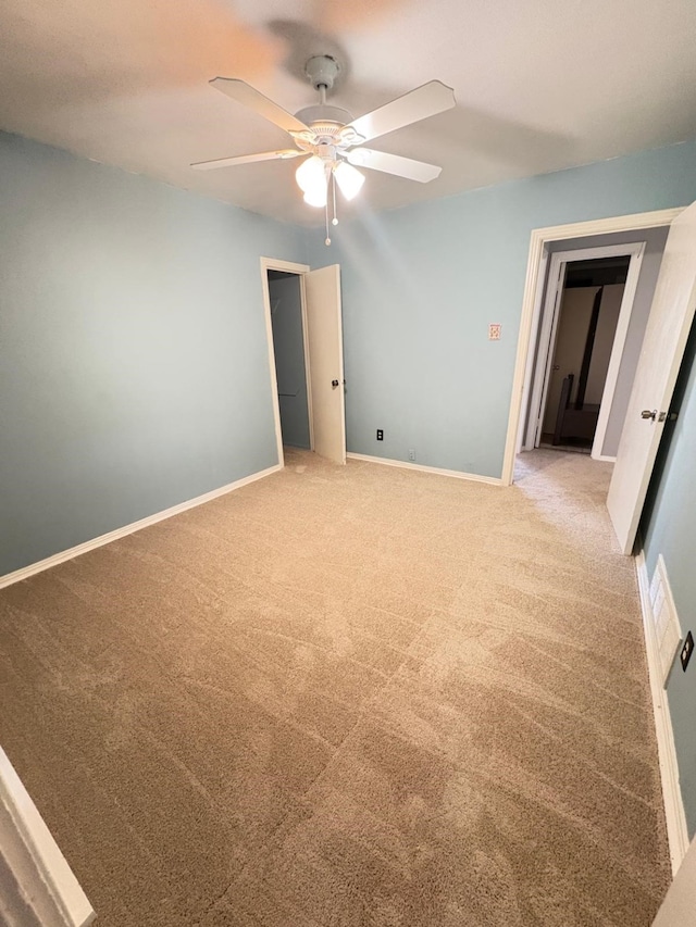 carpeted empty room with ceiling fan