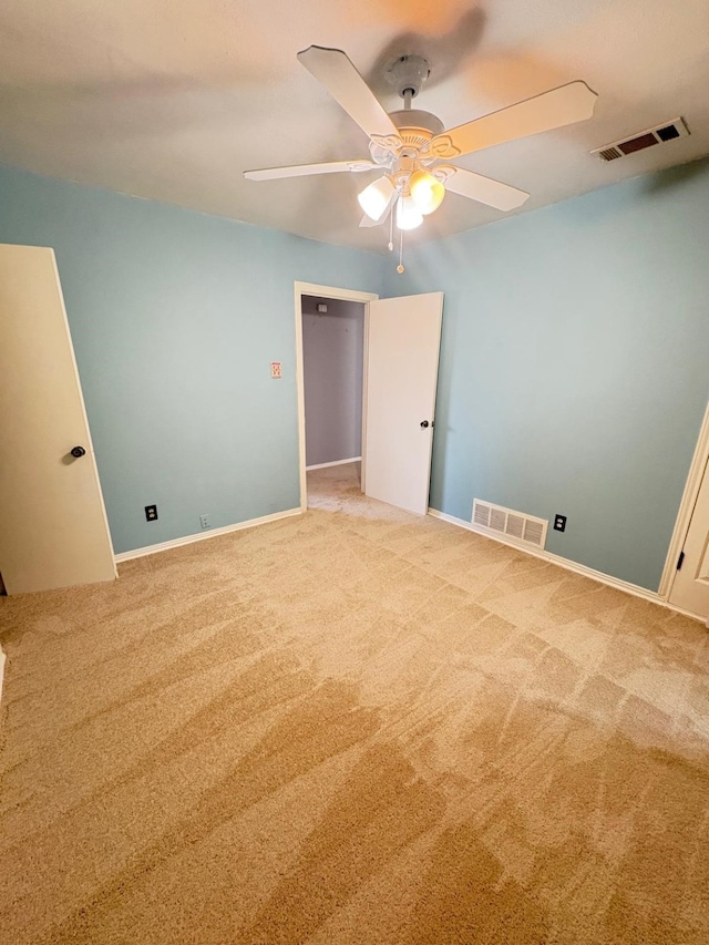 empty room with ceiling fan and light colored carpet