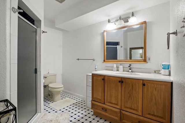 bathroom featuring vanity, an enclosed shower, and toilet