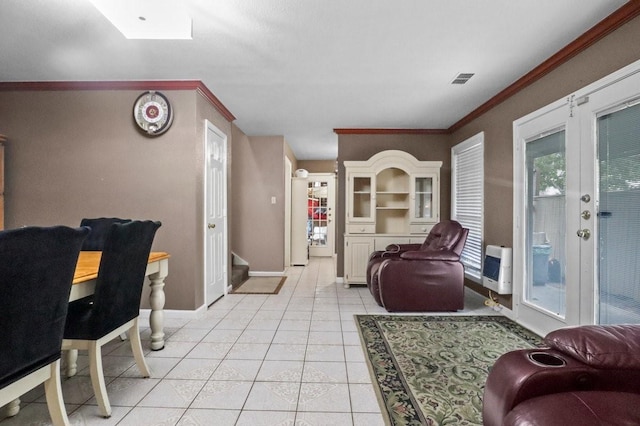 living room featuring crown molding, heating unit, and light tile patterned flooring