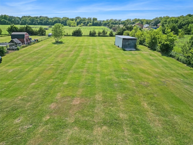 view of yard with an outbuilding and a rural view