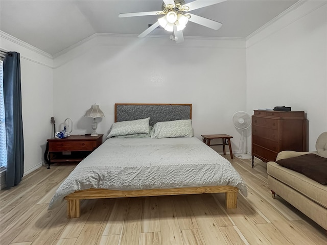 bedroom featuring ceiling fan, wood-type flooring, and crown molding