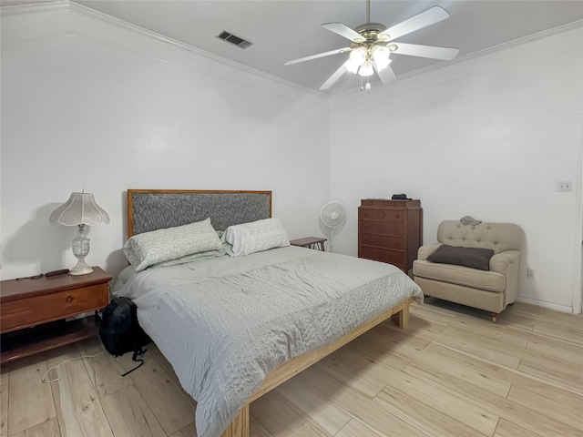 bedroom with ceiling fan, ornamental molding, and light hardwood / wood-style flooring