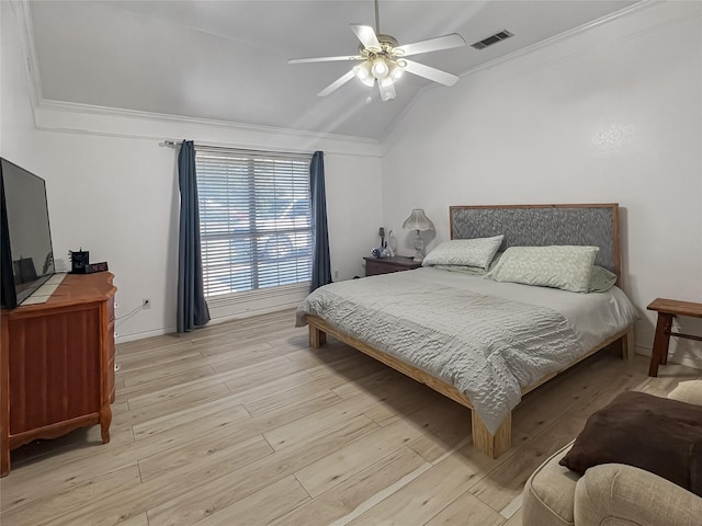 bedroom with vaulted ceiling, ceiling fan, crown molding, and light hardwood / wood-style flooring