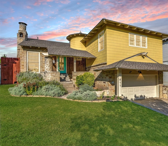 view of front of house with a garage, a lawn, and covered porch