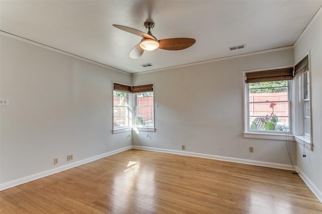 empty room featuring ceiling fan, ornamental molding, and light hardwood / wood-style floors