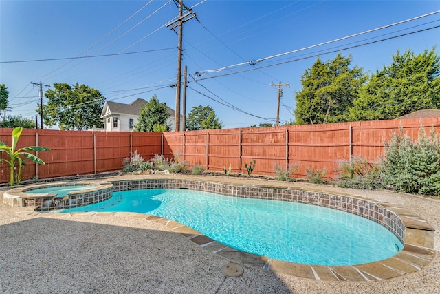 view of swimming pool with an in ground hot tub