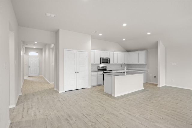 3656 N Crowley Cleburne Rd, Fort Worth, TX 76036 - kitchen featuring appliances with stainless steel finishes, white cabinetry, sink, a center island with sink, and light hardwood / wood-style flooring