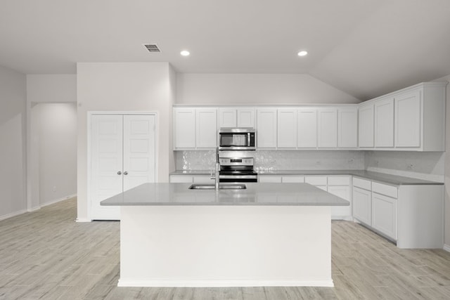 3656 N Crowley Cleburne Rd, Fort Worth, TX 76036 - kitchen featuring white cabinetry, backsplash, a kitchen island with sink, and appliances with stainless steel finishes