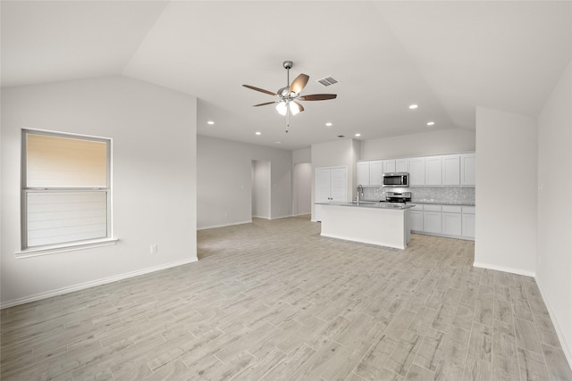 3656 N Crowley Cleburne Rd, Fort Worth, TX 76036 - unfurnished living room with lofted ceiling, sink, light hardwood / wood-style floors, and ceiling fan