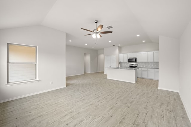 3656 N Crowley Cleburne Rd, Fort Worth, TX 76036 - unfurnished living room with sink, vaulted ceiling, ceiling fan, and light wood-type flooring