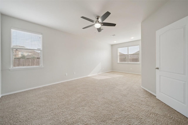 unfurnished room with ceiling fan and light colored carpet