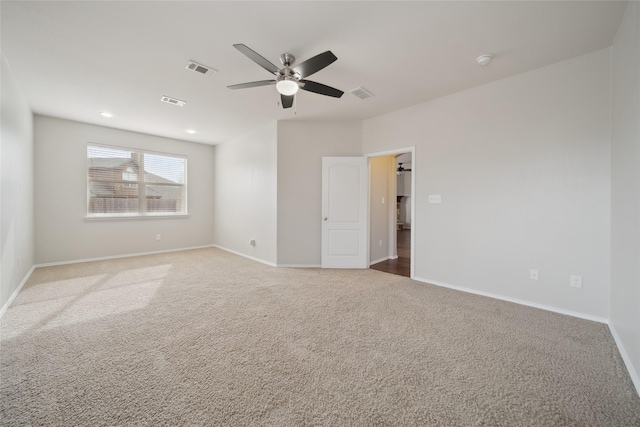 spare room with ceiling fan and carpet flooring