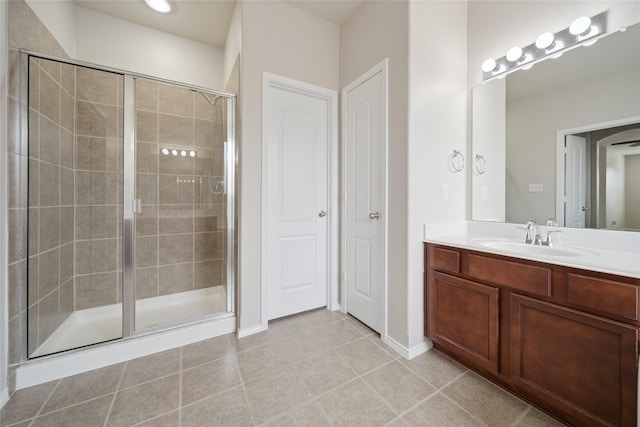 bathroom with walk in shower, vanity, and tile patterned flooring