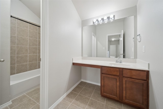 bathroom featuring vanity, vaulted ceiling, and bathing tub / shower combination