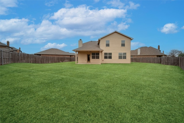 rear view of house with a yard