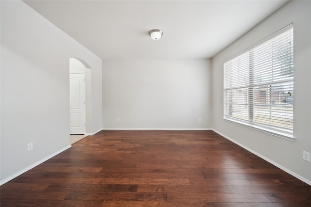 empty room featuring dark hardwood / wood-style flooring